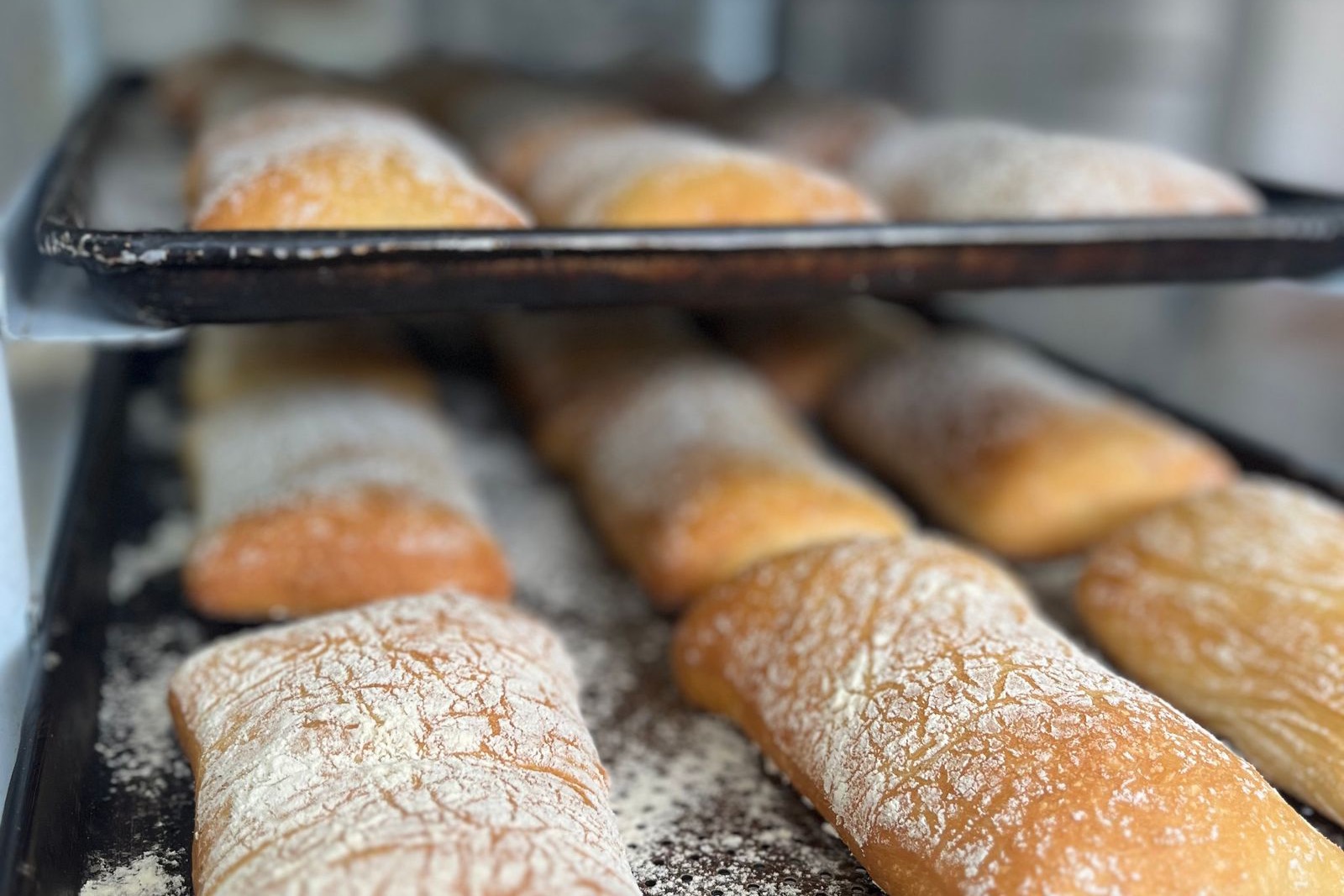 Trays of freshly baked bread inspected by computer vision for size, color and finish before shipping.